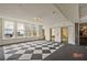 A large checkered floor leads up to brass elevators and large windows providing city views at 57 Forsyth Nw St # 14B, Atlanta, GA 30303