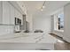 Modern kitchen with white cabinets, stainless steel appliances, and a large marble countertop island at 57 Forsyth Nw St # 14B, Atlanta, GA 30303