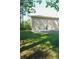 Backyard features a lush lawn with mature trees and an open patio, perfect for recreation at 1010 Forest Overlook Sw Dr, Atlanta, GA 30331
