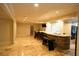 Finished basement features a stone bar with seating, lighting, sink, and marble tile flooring at 1010 Forest Overlook Sw Dr, Atlanta, GA 30331