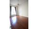 Bedroom features hardwood floors, a window with curtains, and a ceiling fan at 1010 Forest Overlook Sw Dr, Atlanta, GA 30331