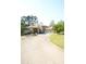 Charming house with mature landscaping, a fountain, and a long driveway leading to the garage at 1010 Forest Overlook Sw Dr, Atlanta, GA 30331