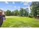 Lush backyard with expansive lawn, mature trees, and serene lake views at 179 Worthington Way, Jonesboro, GA 30236