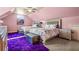 Bedroom with pink walls, carpet flooring, and two beds with matching floral patterned bedspreads at 179 Worthington Way, Jonesboro, GA 30236