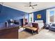 Bedroom with blue walls, ceiling fan, and two windows allowing for lots of natural light at 179 Worthington Way, Jonesboro, GA 30236