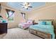 Cozy bedroom featuring two beds, windows with curtains, ceiling fan and carpet flooring at 179 Worthington Way, Jonesboro, GA 30236