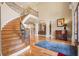 Elegant foyer with a curved staircase, hardwood floors, and soaring ceilings creating a grand entrance at 179 Worthington Way, Jonesboro, GA 30236