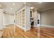 Hallway with hardwood floors, built-in shelves and cabinets, and a small desk in an alcove at 179 Worthington Way, Jonesboro, GA 30236