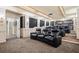 Home theater room featuring plush seating, projector screen, and bar area for entertainment at 179 Worthington Way, Jonesboro, GA 30236