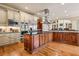 Spacious kitchen featuring custom cabinetry, a large center island, and high-end stainless steel appliances at 179 Worthington Way, Jonesboro, GA 30236