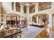 Open living space with high ceilings, large windows, and decorative columns perfect for entertaining at 179 Worthington Way, Jonesboro, GA 30236