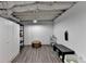 Basement area with vinyl flooring, painted walls, ottoman, and storage at 248 Riverview Trl, Roswell, GA 30075