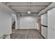 Basement area with vinyl flooring, white walls, access to stairs, and ample storage at 248 Riverview Trl, Roswell, GA 30075