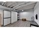 Versatile basement space with vinyl floors, storage cabinets, and painted white walls at 248 Riverview Trl, Roswell, GA 30075