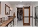 Stylish bathroom features barn door to walk-in closet, vessel sink, and a rustic-chic design at 248 Riverview Trl, Roswell, GA 30075