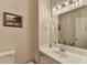 Neutral bathroom with a framed mirror over the white single sink vanity at 248 Riverview Trl, Roswell, GA 30075
