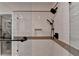 Modern tiled shower with dual shower heads, glass door, and convenient inset shelf at 248 Riverview Trl, Roswell, GA 30075