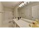 Traditional bathroom featuring tub, shower, white tiled floors and walls, and large vanity at 248 Riverview Trl, Roswell, GA 30075