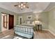 Cozy bedroom boasts tray ceilings, ceiling fan, barn door to bath, and plenty of sunlight at 248 Riverview Trl, Roswell, GA 30075