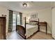 Traditional bedroom with a four-poster bed, wood floors, and ample natural light at 248 Riverview Trl, Roswell, GA 30075