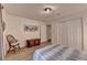 Comfortable bedroom with a full bed, wood floors, a wooden dresser and double door closet at 248 Riverview Trl, Roswell, GA 30075
