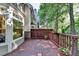 Inviting wooden deck with railings, potted plants, and peaceful wooded surroundings at 248 Riverview Trl, Roswell, GA 30075