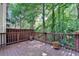 Inviting wooden deck with wood railings and flowerpots, offering a serene outdoor space surrounded by lush greenery at 248 Riverview Trl, Roswell, GA 30075