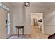 Inviting entryway with light wood flooring, a classic table, and views into the adjacent kitchen at 248 Riverview Trl, Roswell, GA 30075