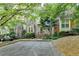 Charming townhome featuring a brick facade, manicured landscaping, and a welcoming entrance framed by lush greenery at 248 Riverview Trl, Roswell, GA 30075