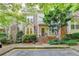 Charming townhome featuring a brick facade, manicured landscaping, and a welcoming entrance framed by lush greenery at 248 Riverview Trl, Roswell, GA 30075