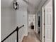 Upstairs hallway showcasing modern lighting, wood floors, and multiple entryways at 248 Riverview Trl, Roswell, GA 30075