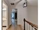Bright hallway with hardwood floors, modern light fixture, and views into the bathroom and bedroom at 248 Riverview Trl, Roswell, GA 30075
