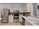 Well-equipped kitchen with stainless steel appliances, white cabinets, and a light, modern design at 248 Riverview Trl, Roswell, GA 30075
