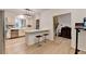 Well-lit kitchen with white cabinets, stainless steel appliances, breakfast bar, and adjacent staircase at 248 Riverview Trl, Roswell, GA 30075