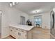 Open-concept kitchen with white cabinetry, a breakfast bar, and adjacent office space at 248 Riverview Trl, Roswell, GA 30075