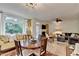 Open-concept living space featuring a cozy seating area, fireplace, and dining area with abundant natural light at 248 Riverview Trl, Roswell, GA 30075