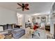 Spacious living room with fireplace, multiple seating areas, and views into the dining area and kitchen at 248 Riverview Trl, Roswell, GA 30075