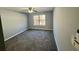 Spacious bedroom with plush carpeting, ceiling fan, and a bright window at 2572 Laurel Cir, Atlanta, GA 30311