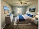 Serene bedroom featuring a ceiling fan, plush carpet, and a bright window at 2572 Laurel Cir, Atlanta, GA 30311