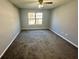 Well-lit bedroom showcasing neutral paint, plush carpet, and a window that illuminates the space at 2572 Laurel Cir, Atlanta, GA 30311