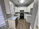 Well-lit kitchen with white cabinets, modern appliances, and durable countertops at 2572 Laurel Cir, Atlanta, GA 30311