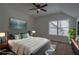 Staged bedroom with ceiling fan, modern decor, and a large window at 3007 Holly St, Canton, GA 30115