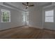 Bright bedroom with hardwood floors, tray ceiling, and many windows overlooking a private wooded lot at 3007 Holly St, Canton, GA 30115