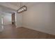 Open dining room with hardwood floors, modern light fixture, and easy access to other living spaces at 3007 Holly St, Canton, GA 30115