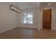 Dining area with hardwood floors, modern light fixture, and a view of the outdoor landscape at 3007 Holly St, Canton, GA 30115