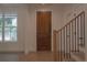 Bright foyer with a wooden front door, staircase, and hardwood floors creating a welcoming entrance at 3007 Holly St, Canton, GA 30115