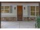 Inviting entryway featuring a solid wood front door, stone accents, and stylish exterior lighting at 3007 Holly St, Canton, GA 30115