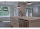 Open kitchen featuring large island with stainless steel dishwasher and farmhouse sink at 3007 Holly St, Canton, GA 30115