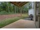 Covered patio area with view of the wooded backyard and landscaping at 3007 Holly St, Canton, GA 30115