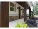 Covered porch with stone accents, wooden beams, and well-maintained landscaping enhances curb appeal at 3007 Holly St, Canton, GA 30115